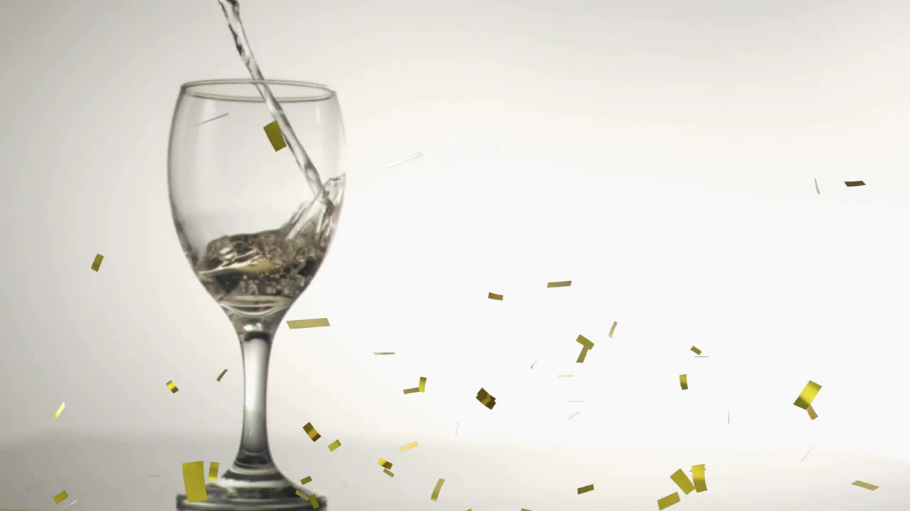 Animation of confetti over white wine pouring into glass on white background