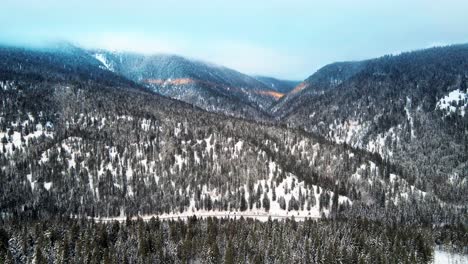 Beautiful-Drone-Pullback-Shot-of-cloudy-and-foggy-Tree-Covered-Mountains-in-the-Thompson-Nicola-Region,-BC,-Canada