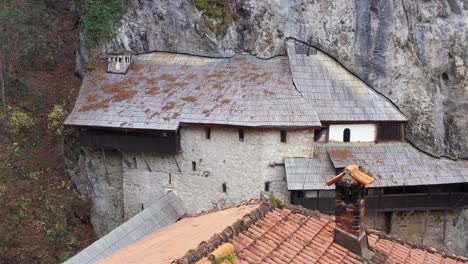 monastery built into mountainside rock, old historical architectural building