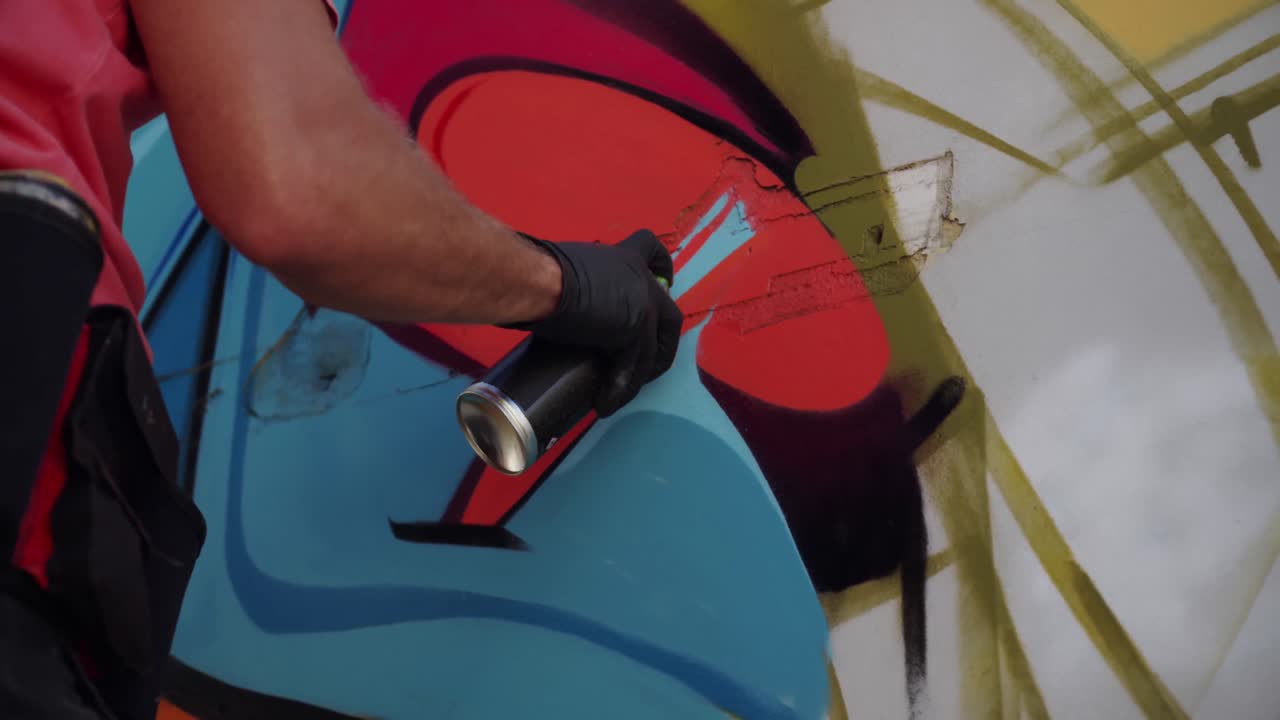 artista graffiti che dipinge con spray aerosol 4k