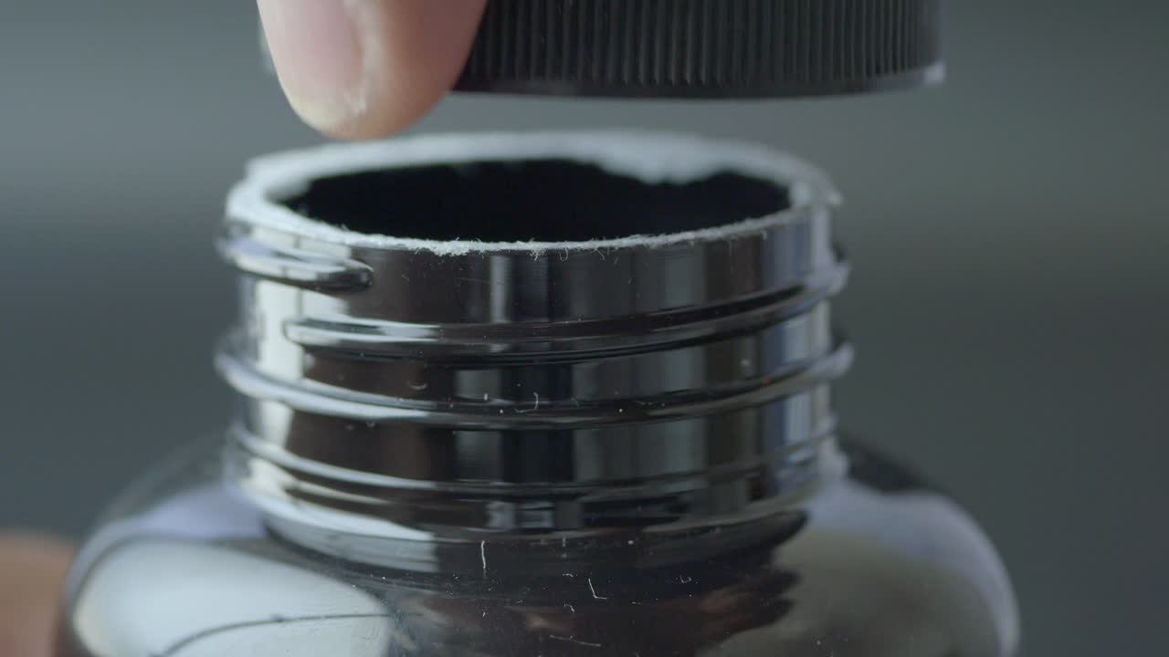 Person Opening a Bottle Cap