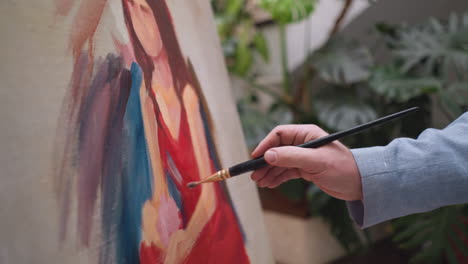 woman portrait evolves with each stroke. painter demonstrates strategic placement of highlights and shadows during painting on canvas in drawing studio