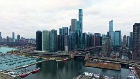 Aerial-view-toward-the-New-Eastside-skyline,-snowless-winter-day-in-Chicago,-USA