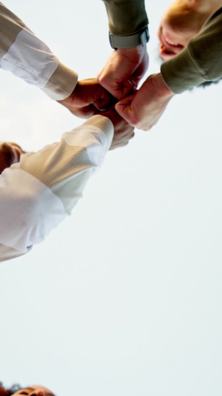 Diverse Group of Friends Joining Hands in Unity