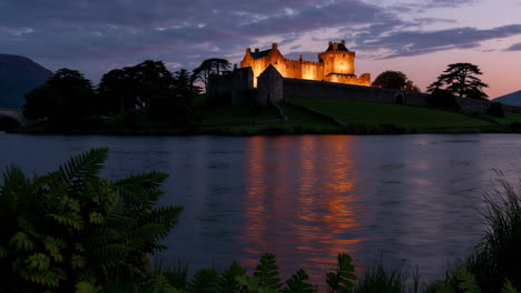 eilean donan castle illuminated at dusk