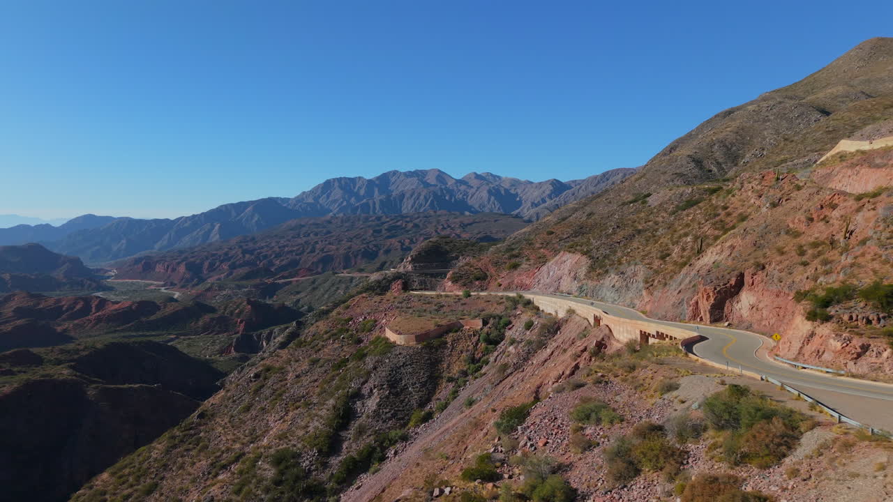 Cuesta de Miranda mountain road winds through colorful hills along Ruta 40, near Chilecito, La Rioja, Argentina