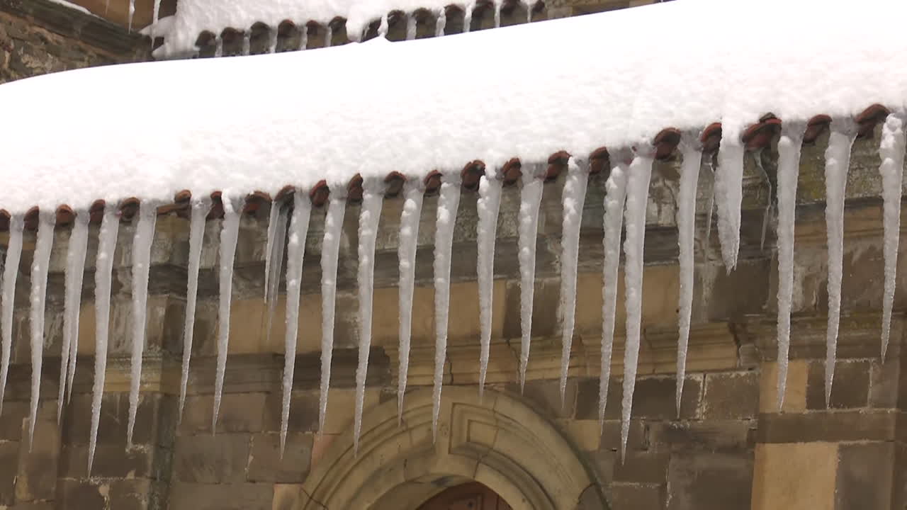 Icicles on a Snow-Covered Roof