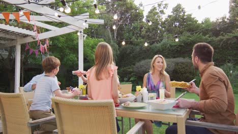 Three-generation-family-enjoying-lunch-outdoors