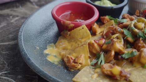 delicious chicken nachos with salsa and guacamole