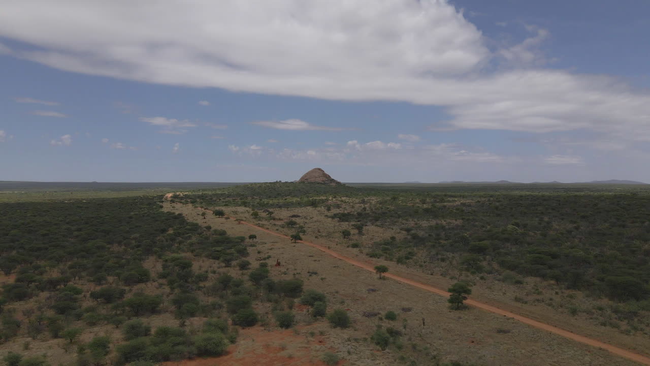 breathtaking drone view of a Jeep navigating Namibia's vast landscapes, showcasing stunning deserts, rugged terrain, and endless horizons in an epic adventure through nature's beauty.
