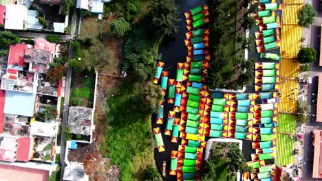 drone shot of the floating gardens of xochimilco, located in mexico , boats in canals, southern suburb of mexico,things to do mexico city