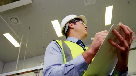 inspection officer writing on clipboard