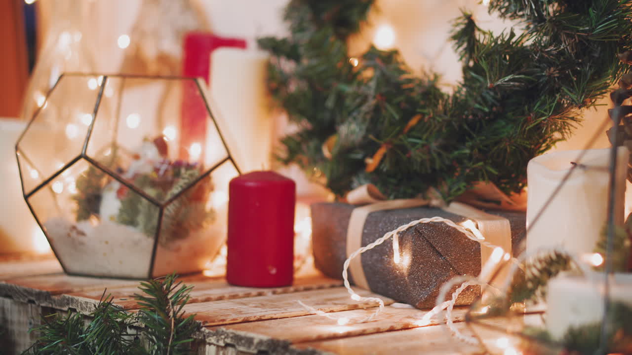 Woman's hands hold christmas or new year decorated gift box.