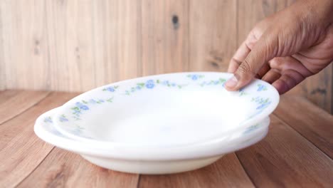 putting empty plate on table