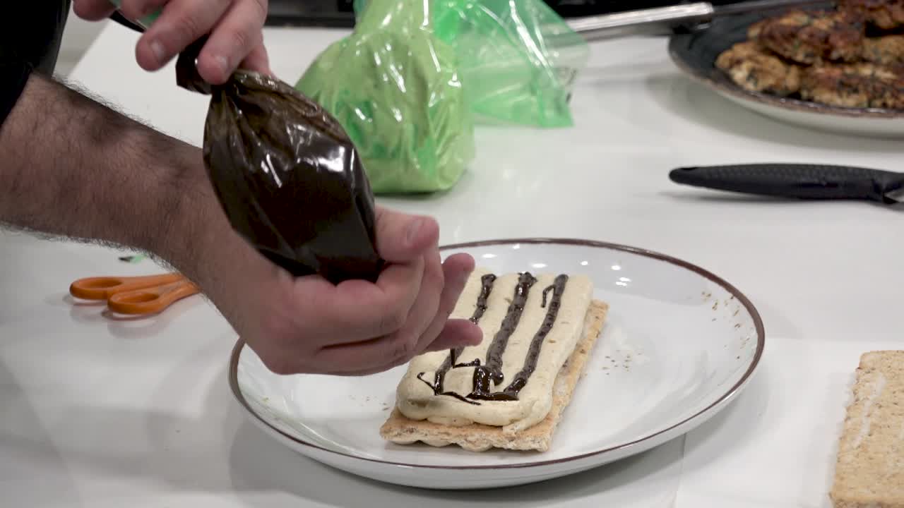 In a hands-on baking class, an instructor demonstrates how to prepare a pastry cream dessert