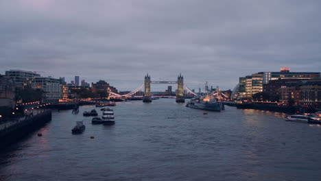 panoramic view of the tower bridge in london at dawn, with lovely light reflections in the thames