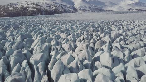 aerial: close up of largest glacier in europe vatnajokull. beautiful glaciers flow through the mountains in iceland. concept of global warming skaftafell glacier, vatnajokull national park in iceland.