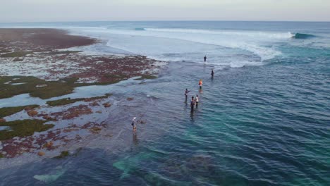 bali fishermen fishing on uluwatu ocean coast in indonesia, aerial