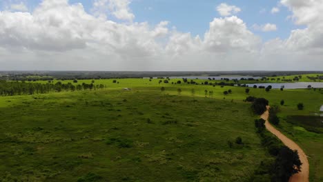 Aerial-Shot-of-old-dirt-road-beside-the-lake