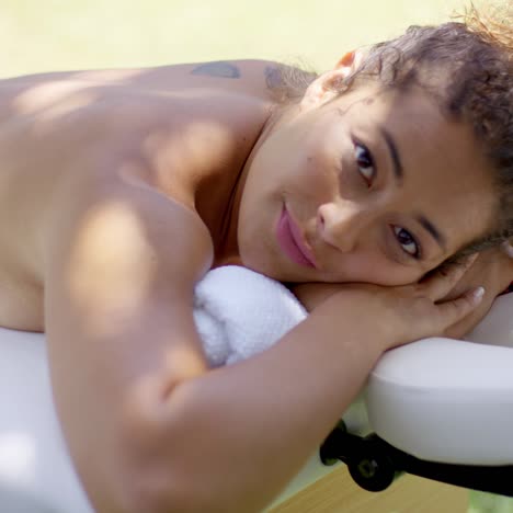 woman laying down on massage table at spa