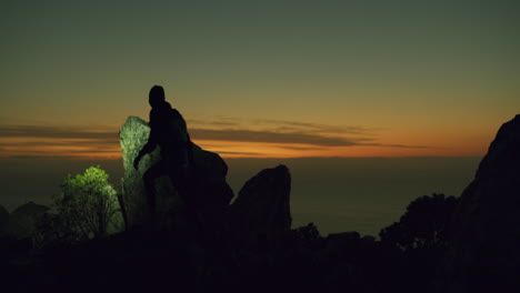 silhouette of a hiker at sunset mountain view