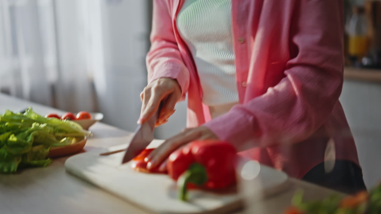 Hands chopping red pepper kitchen countertop closeup. Happy woman preparing meal