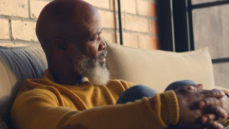 senior man relaxing in living room 4k