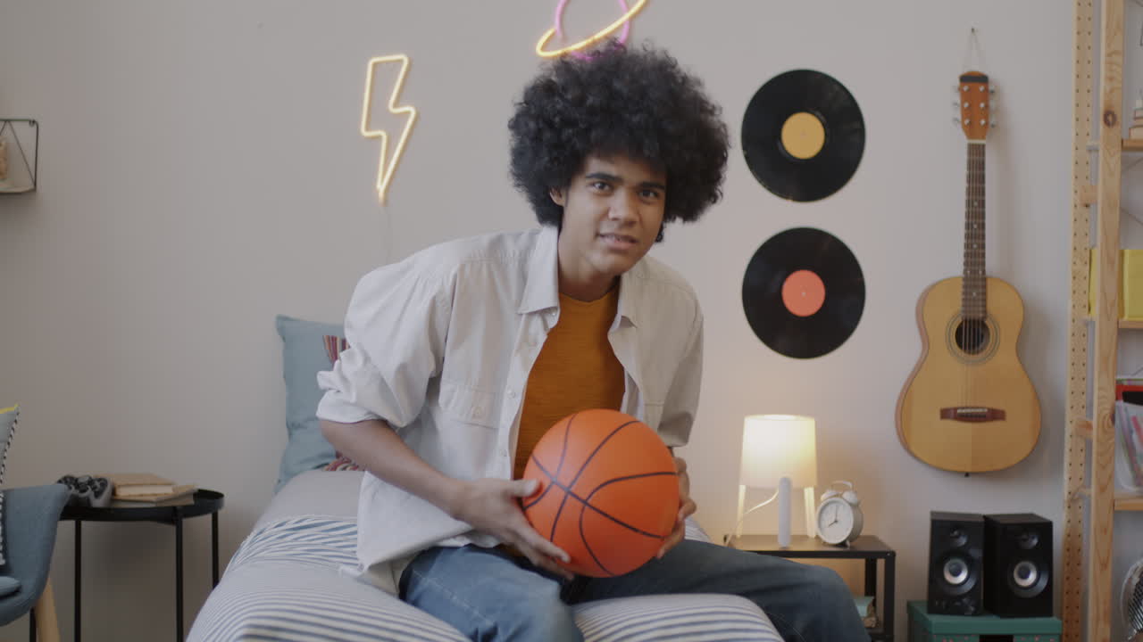 Teenager with Basketball in Bedroom