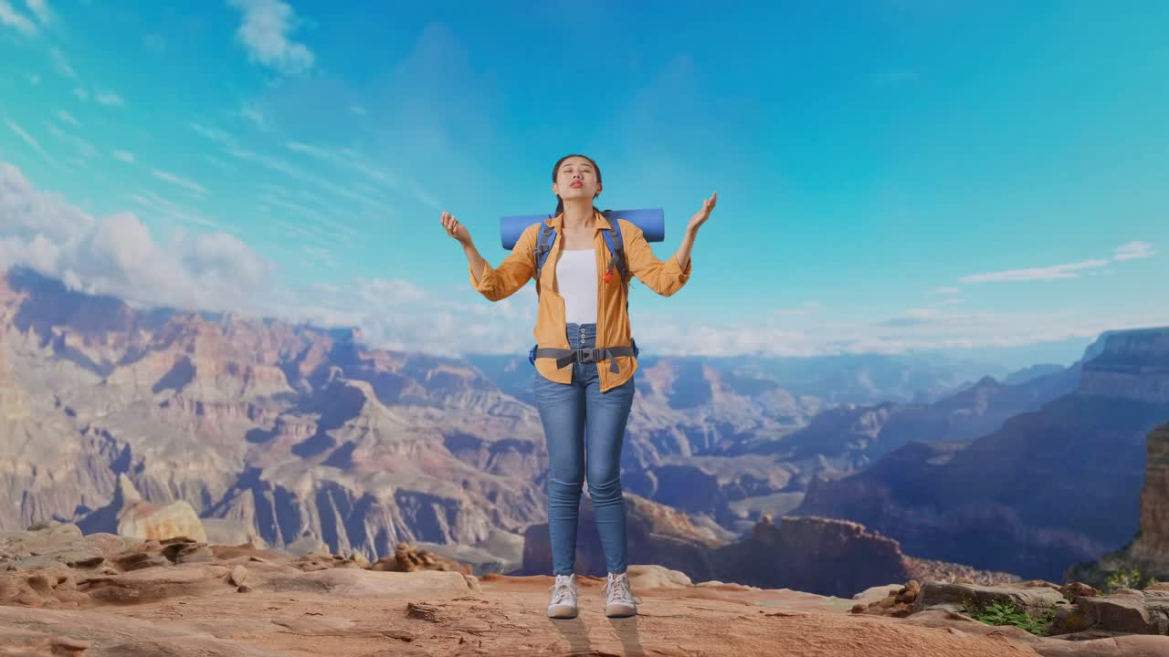 Full Body Of Asian Female Hiker With Mountaineering Backpack Spreading Arms Enjoy Looking The View Around While Traveling At The Top Of Mountain