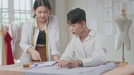 two fashion designers working with fabrics