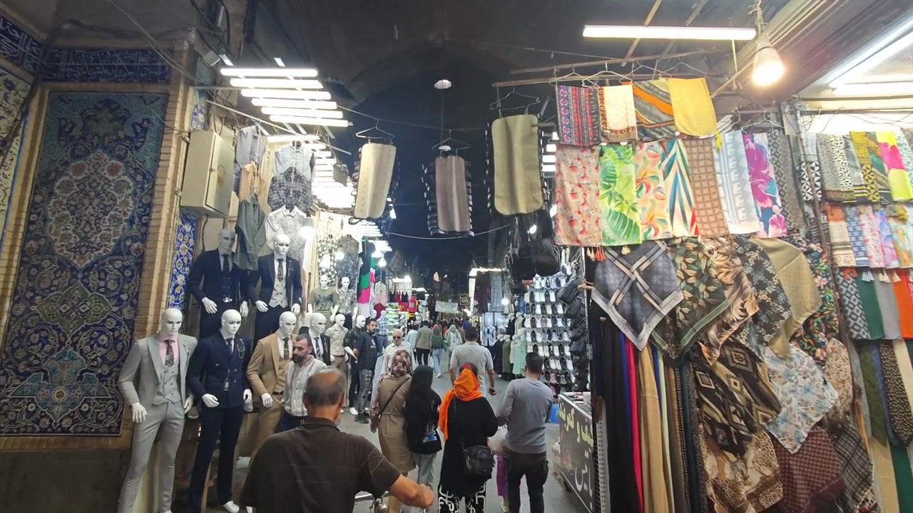 Drukke bazaarsteeg met kleding- en accessoirewinkels