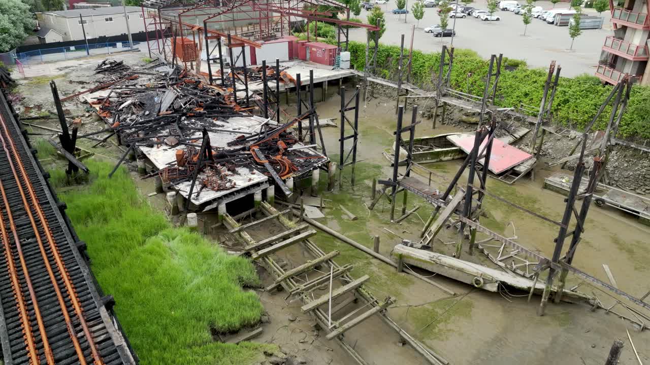 Aftermath Of A Fire On The Burned Building Next To the Railroad Bridge In Bridgeport, Richmond, Canada. - aerial shot