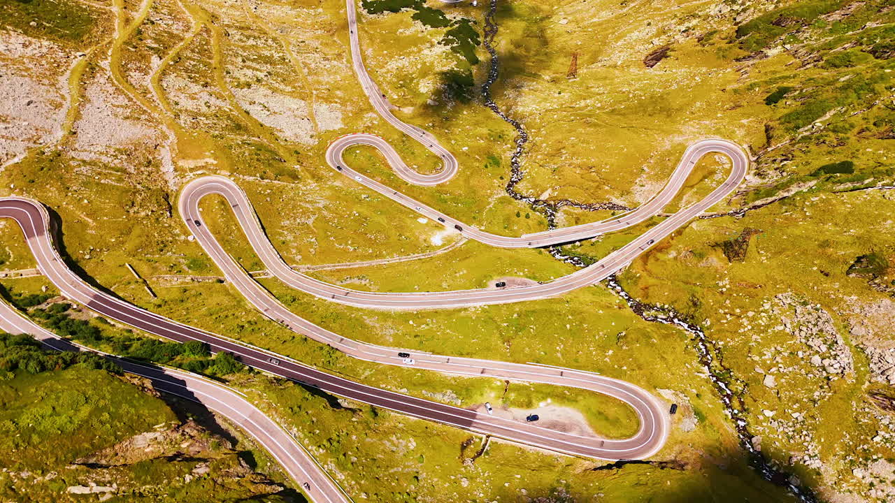 Drone shot of winding Transfagarasan highway in the Carpathians. The serpentine Transfagarasan road winds dramatically through Romania mountains