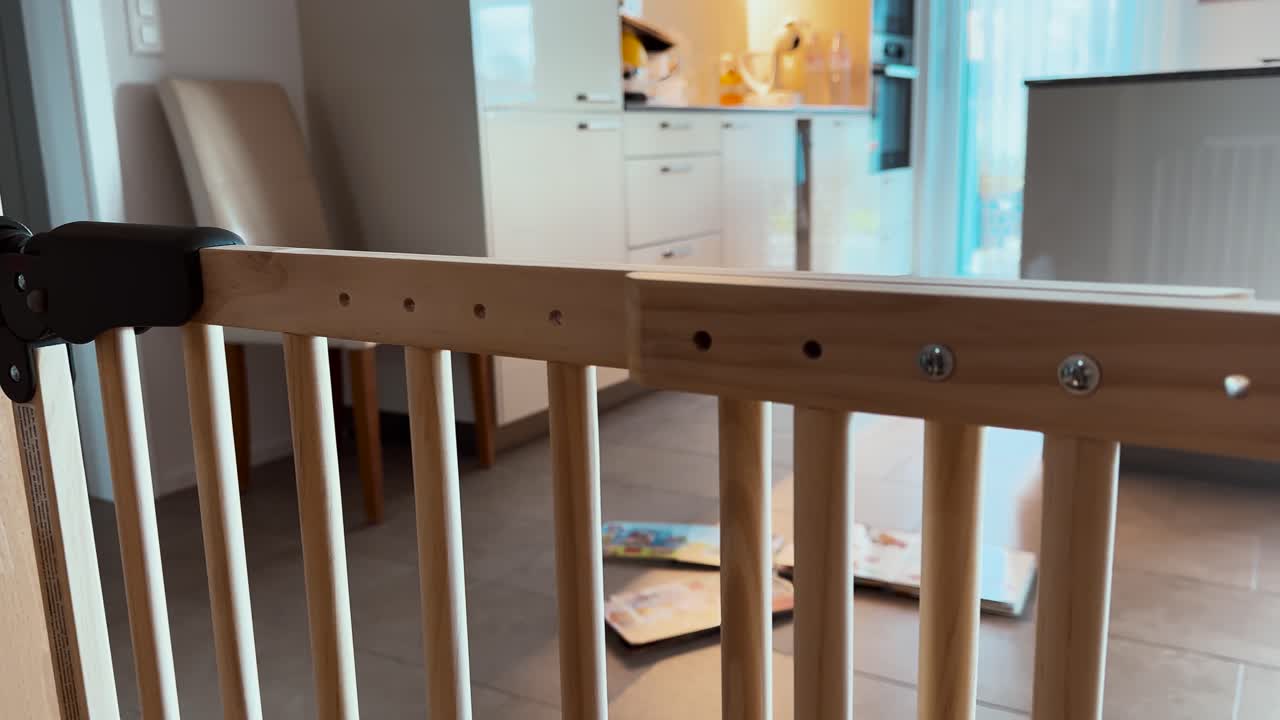 A detailed close-up of a baby safety gate mounted at a staircase, showing secure installation and focus on child safety at home