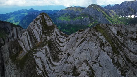 4k drone aerial close up shot of jagged rock peaks at shäfler ridge in appenzell region of switzerland