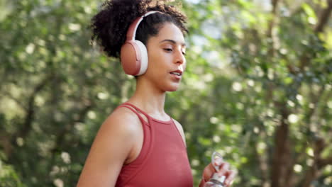 Woman,-running-and-drinking-water-in-headphones