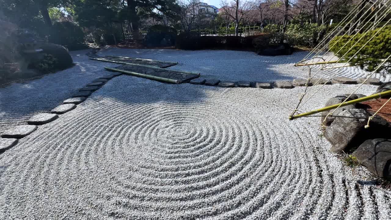 Tranquil Japanese garden with gravel and stone paths forming circular patterns