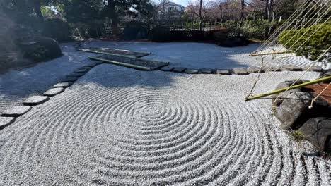 tranquil japanese garden with gravel and stone paths forming circular patterns