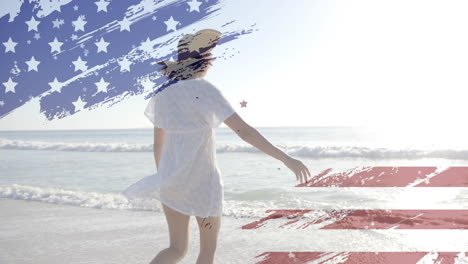 animation of flag of usa over a biracial woman on beach in summer