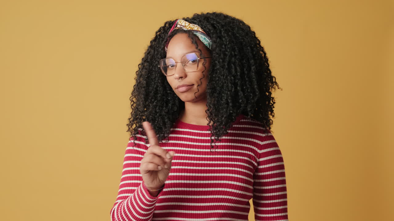 Young Woman Gesturing Stop and Warning with Finger