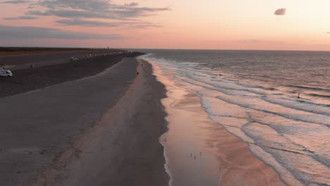 kitesurfers near the beach of domburg during sunset