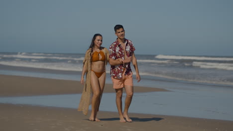 cute couple walking on the beach