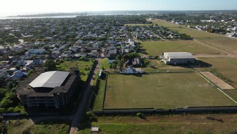 lateral movement with drone and then orbital around a stadium and football field in the interior of Argentina, sunny light of dawn