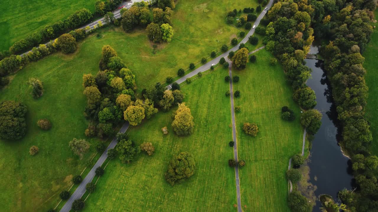 Drone footage of a lush green estate in Ireland with trees and a river