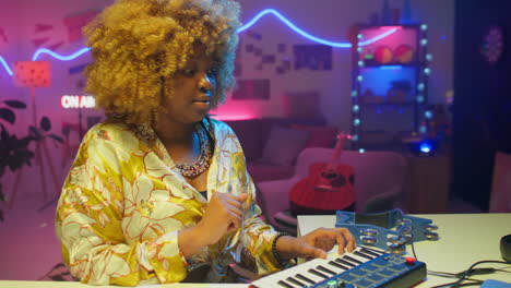 woman playing keyboard in a colorful music studio