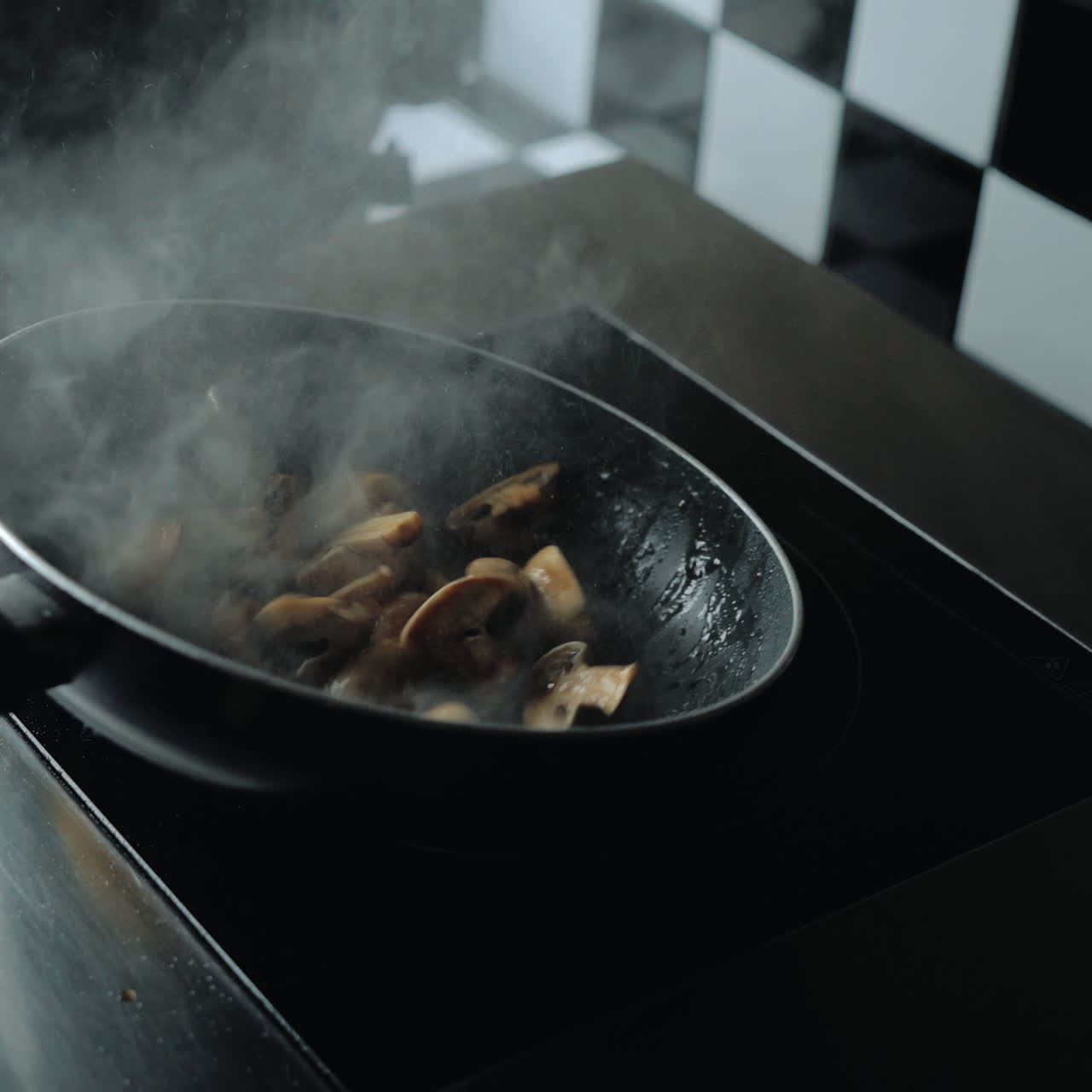 Chef cooks mushrooms in a frying pan. Professional cooking. Sqare video