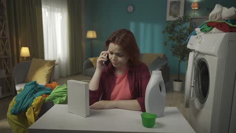 woman on phone doing laundry