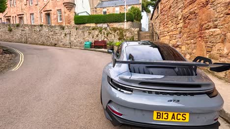 a car navigates a narrow street in crail