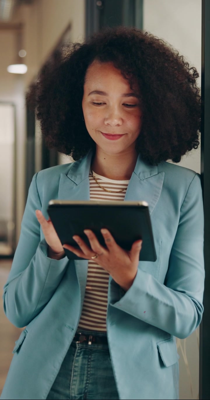 Professional Woman Using Tablet in Modern Office