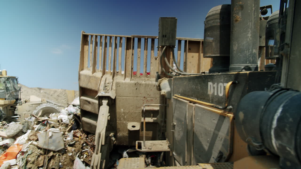 Heavy machinery working in a large landfill